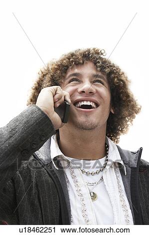Stock Image - Man Talking on Cell Phone, head and shoulders. Fotosearch