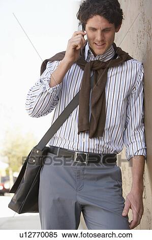 Stock Photography - Man using mobile phone, outdoors. Fotosearch