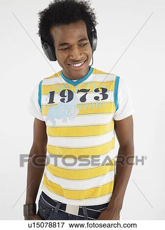 Stock Photo - Man wearing headphones in studio. Fotosearch