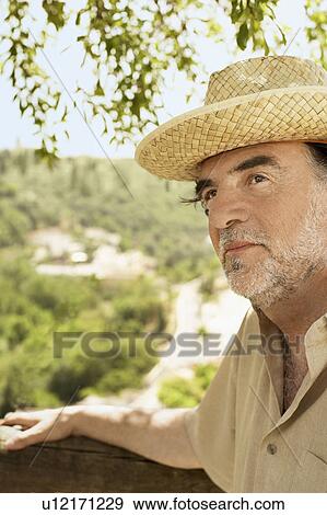 Man wearing straw hat, close-up. View Large Photo Image Stock Photo - Man wearing straw hat, close-up.. Fotosearch