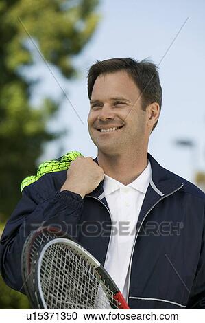 Stock Image - Man with Tennis Racket and tennis balls. Fotosearch