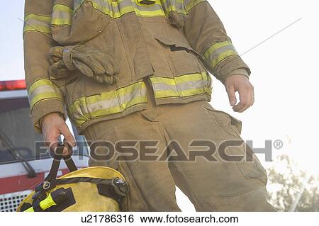 Stock Photograph - Mid section of a firefighter. Fotosearch
