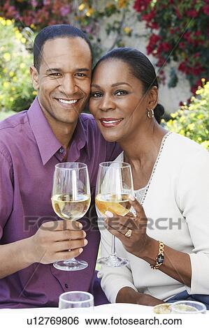 Middle aged couple celebrating with champagne, outdoors View Large Photo Image Stock Photograph - Middle aged couple celebrating with champagne, outdoors. Fotosearch