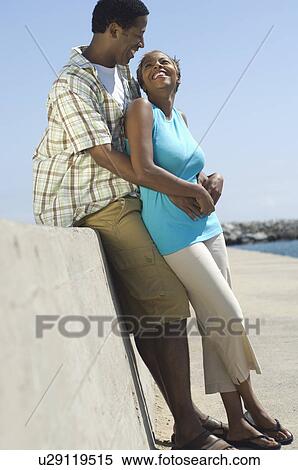 Stock Photography - Middle-aged couple embracing at promenade. Fotosearch