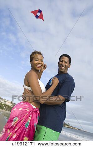 Middle-aged couple flying kite View Large Photo Image Stock Image - Middle-aged couple flying kite. Fotosearch
