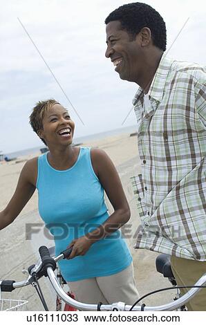 Middle-aged couples standing with bicycles View Large Photo Image Stock Image - Middle-aged couples standing with bicycles. Fotosearch