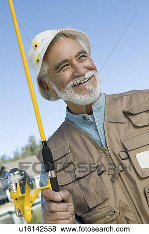 Middle-aged fisherman outdoors View Large Photo Image Stock Photo - Middle-aged fisherman outdoors. Fotosearch