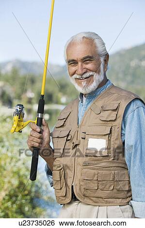 Stock Photograph - Middle-aged fisherman outdoors, (portrait). Fotosearch