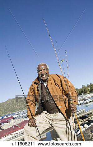 Middle-aged fisherman standing at marina, (portrait) View Large Photo Image Stock Image - Middle-aged fisherman standing at marina, (portrait). Fotosearch