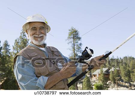 Middle-aged man fishing, smiling, (portrait) View Large Photo Image Stock Photo - Middle-aged man fishing, smiling, (portrait). Fotosearch