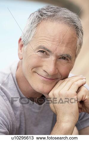 Middle-aged man sitting by pool, portrait View Large Photo Image Stock Image - Middle-aged man sitting by pool, portrait. Fotosearch