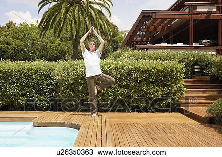 Middle-aged man standing by swimming pool doing tai chi View Large Photo Image Stock Image - Middle-aged man standing by swimming pool doing tai chi. Fotosearch