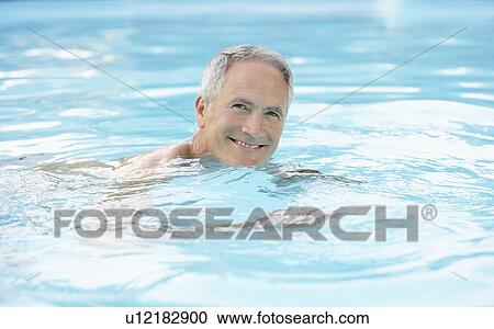 Middle-aged man swimming in pool, portrait View Large Photo Image Stock Image - Middle-aged man swimming in pool, portrait. Fotosearch