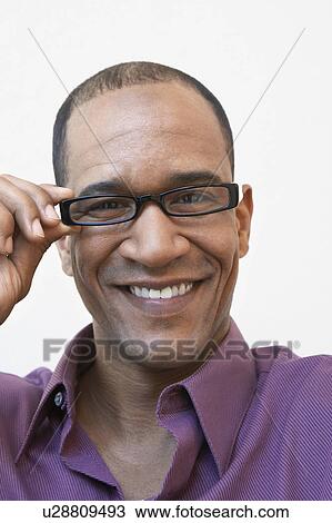 Stock Image - Middle aged man wearing glasses, portrait. Fotosearch