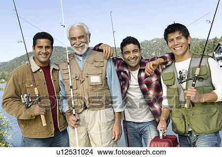 Middle-aged man with three sons holding fishing rods, smiling, (portrait) View Large Photo Image Picture - Middle-aged man with three sons holding fishing rods, smiling, (portrait). Fotosearch