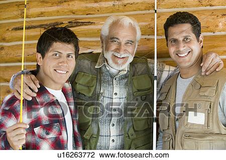 Middle-aged man with two sons holding fishing rods, smiling, (portrait) View Large Photo Image Stock Image - Middle-aged man with two sons holding fishing rods, smiling, (portrait). Fotosearch
