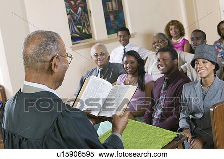 Stock Photography - Minister Giving Sermon to congregation in Church, back view. Fotosearch