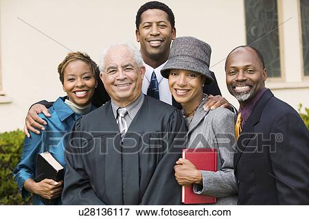 Minister with Family in church garden, portrait View Large Photo Image Stock Photo - Minister with Family in church garden, portrait. Fotosearch