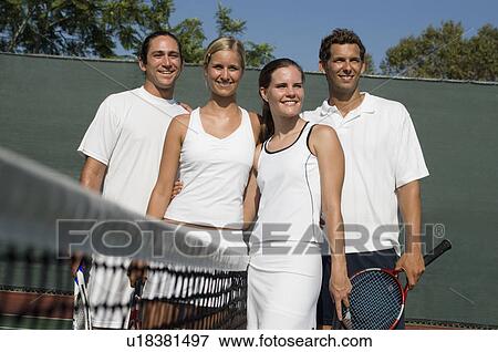 Stock Photo - Mixed Doubles Tennis Players standing at Net, arms around. Fotosearch