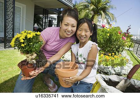 Mother and daughter gardening, (portrait) View Large Photo Image Stock Image - Mother and daughter gardening, (portrait). Fotosearch