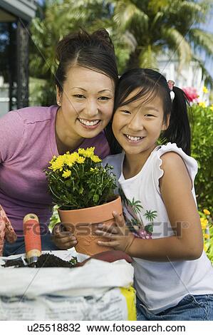 Mother and daughter gardening, (portrait) View Large Photo Image Stock Image - Mother and daughter gardening, (portrait). Fotosearch