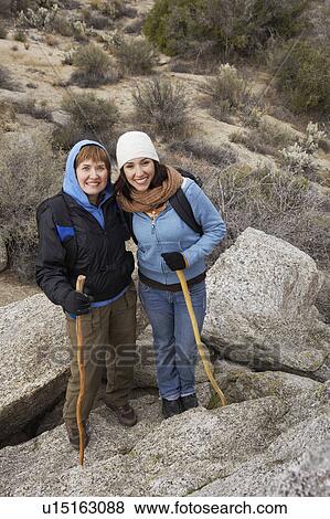 Stock Photo - Mother and daughter hiking in desert, (portrait). Fotosearch