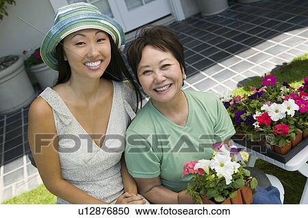 Mother and daughter with flowers, smiling, (portrait) View Large Photo Image Stock Image - Mother and daughter with flowers, smiling, (portrait). Fotosearch