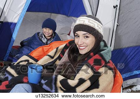 Mother and son (7-9) in tent, (portrait) View Large Photo Image Picture - Mother and son (7-9) in tent, (portrait). Fotosearch