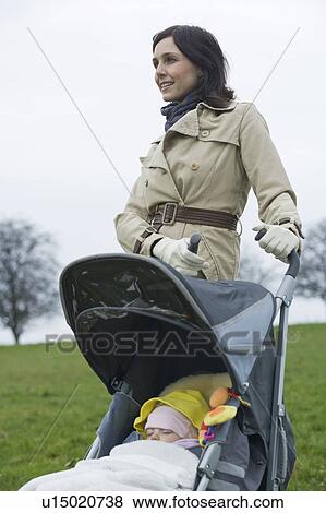 Mother in park with baby in stroller View Large Photo Image Stock Photo - Mother in park with baby in stroller. Fotosearch