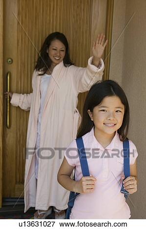 Mother Waving goodbye to daughter going to school in morning View Large Photo Image Stock Photo - Mother Waving goodbye to daughter going to school in morning. Fotosearch