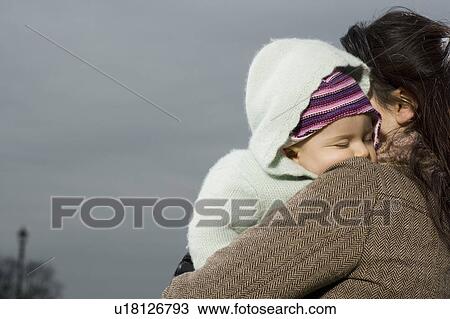 Mother with baby sleeping in her arms View Large Photo Image Stock Image - Mother with baby sleeping in her arms. Fotosearch