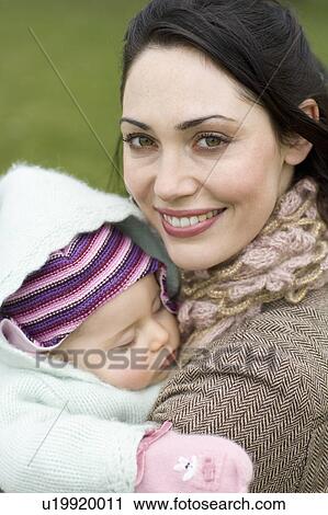 Mother with baby sleeping in her arms View Large Photo Image Stock Image - Mother with baby sleeping in her arms. Fotosearch