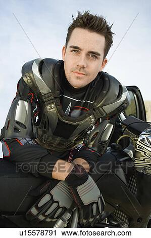 Stock Image - Motocross racer, outdoors, (portrait). Fotosearch