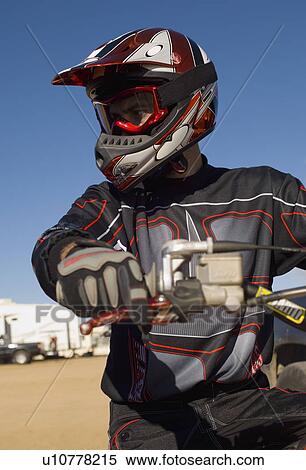 Stock Photography - Motocross racer, outdoors. Fotosearch