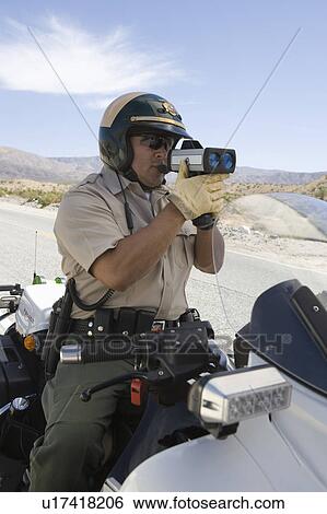 Motorcycle police officer with speed radar View Large Photo Image Stock Photograph - Motorcycle police officer with speed radar. Fotosearch