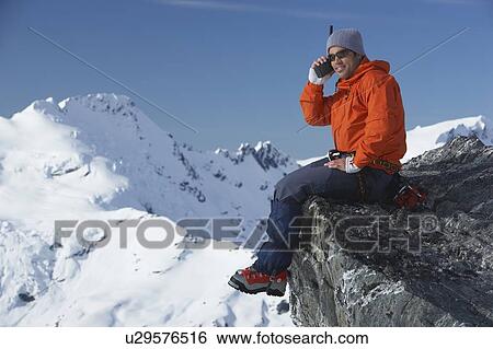 Mountain climber using walkie-talkie on mountain peak View Large Photo Image Stock Photograph - Mountain climber using walkie-talkie on mountain peak. Fotosearch