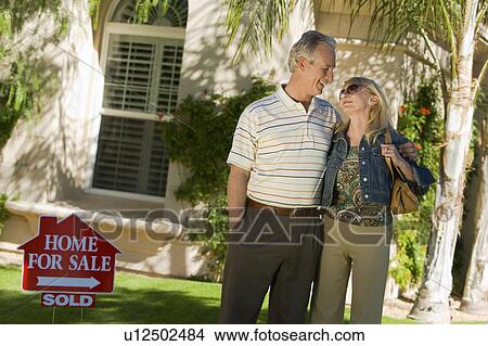 Picture - New home owners in front yard, portrait. Fotosearch