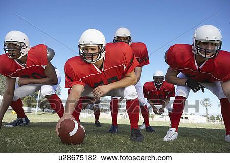 Offensive line ready to hike football on field View Large Photo Image Stock Image - Offensive line ready to hike football on field. Fotosearch