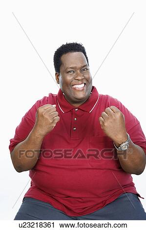 Overweight Man sitting arms raised, smiling, portrait View Large Photo Image Stock Image - Overweight Man sitting arms raised, smiling, portrait. Fotosearch