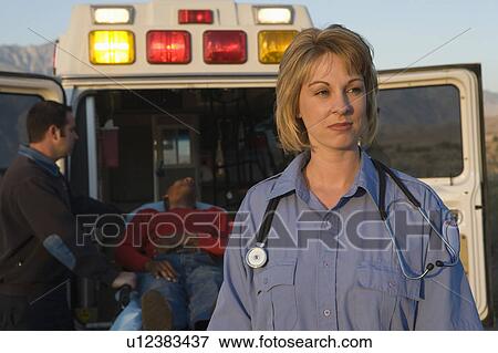 Stock Photo - Paramedic stands near ambulance. Fotosearch