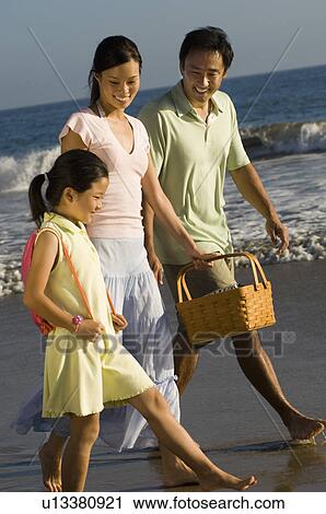 Parents and daughter (7-9) walking on beach View Large Photo Image Stock Image - Parents and daughter (7-9) walking on beach. Fotosearch