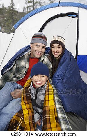 Parents and son (7-9) by tent, (portrait) View Large Photo Image Picture - Parents and son (7-9) by tent, (portrait). Fotosearch