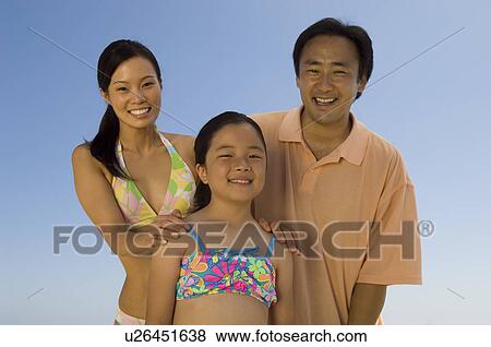 Parents with daughter (7-9), outdoors, (portrait) View Large Photo Image Stock Photo - Parents with daughter (7-9), outdoors, (portrait). Fotosearch