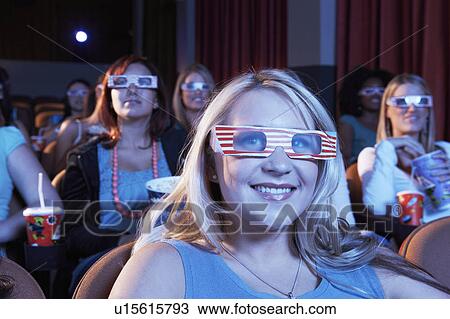 People wearing 3-d glasses watching 3-D movie in theatre View Large Photo Image Stock Image - People wearing 3-d glasses watching 3-D movie in theatre. Fotosearch