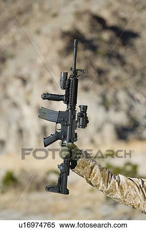 Person holding rifle, outdoors View Large Photo Image Stock Photography - Person holding rifle, outdoors. Fotosearch