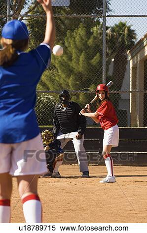 Pitcher throwing softball to batter View Large Photo Image Stock Photography - Pitcher throwing softball to batter. Fotosearch