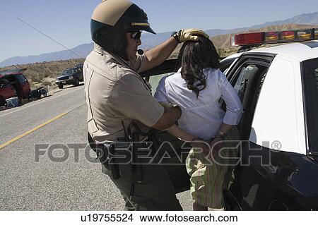 Police officer arrests female driver View Large Photo Image Picture - Police officer arrests female driver. Fotosearch
