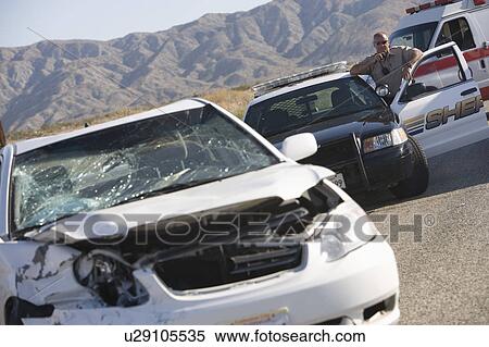 Police officer arrives at scene of carcrash View Large Photo Image Stock Photography - Police officer arrives at scene of carcrash. Fotosearch