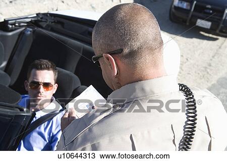 Police officer checks male drivers papers View Large Photo Image Stock Image - Police officer checks male drivers papers. Fotosearch