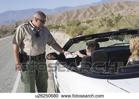 Police officer examines papers of convertible driver View Large Photo Image Stock Image - Police officer examines papers of convertible driver. Fotosearch